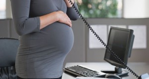 A pregnant woman working in office