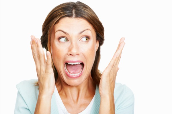 Closeup of shocked woman over white background