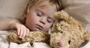cute young baby toddler asleep with teddy bear